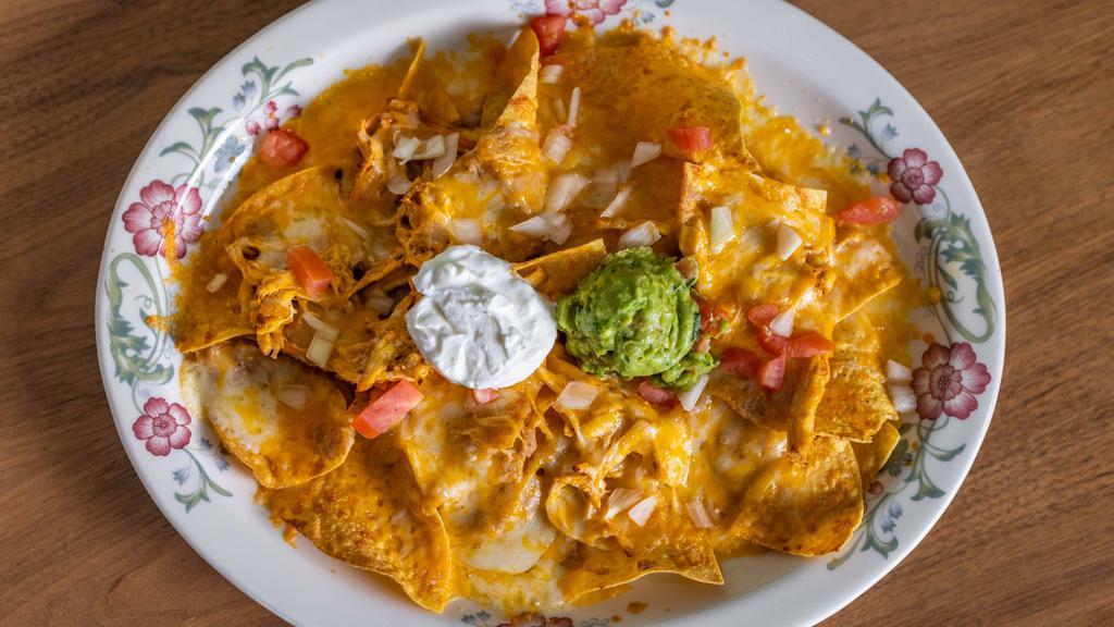 Super Nachos · Chips, beans and Cheddar cheese melted with your choice of chicken or ground beef. Topped with tomatoes, onions, sour cream and guacamole.