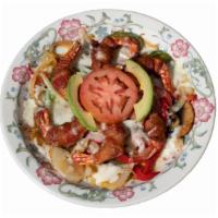 Camarones Con Tocino · Shrimped wrapped with bacon set on top of a bed of grilled bell peppers, onion, mushrooms an...