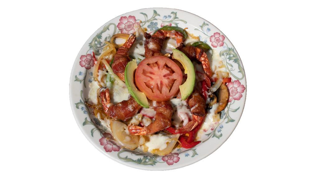 Camarones Con Tocino · Shrimped wrapped with bacon set on top of a bed of grilled bell peppers, onion, mushrooms and tomatoes. Topped with melted Monterrey Jack cheese, sliced avocados and lime.
