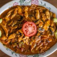 Arroz Con Pollo · Our signature item! Tender sliced chicken breast specially prepared with fresh mushrooms, on...