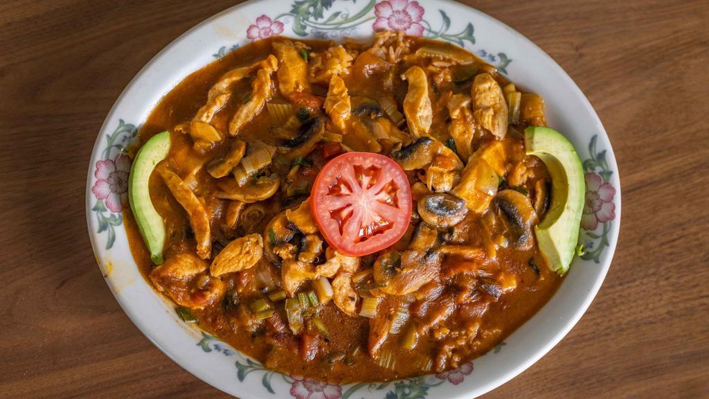 Arroz Con Pollo · Our signature item! Tender sliced chicken breast specially prepared with fresh mushrooms, onions and green peppers. Served on a bed of rice, melted Monterey Jack cheese, smothered with our special mild sauce an garnished with avocado and tomatoes. Served with warm tortillas.