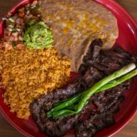 Carne Asada · Premium skirt steak, flame broiled to customers preference. Served with rice, beans, pico de...