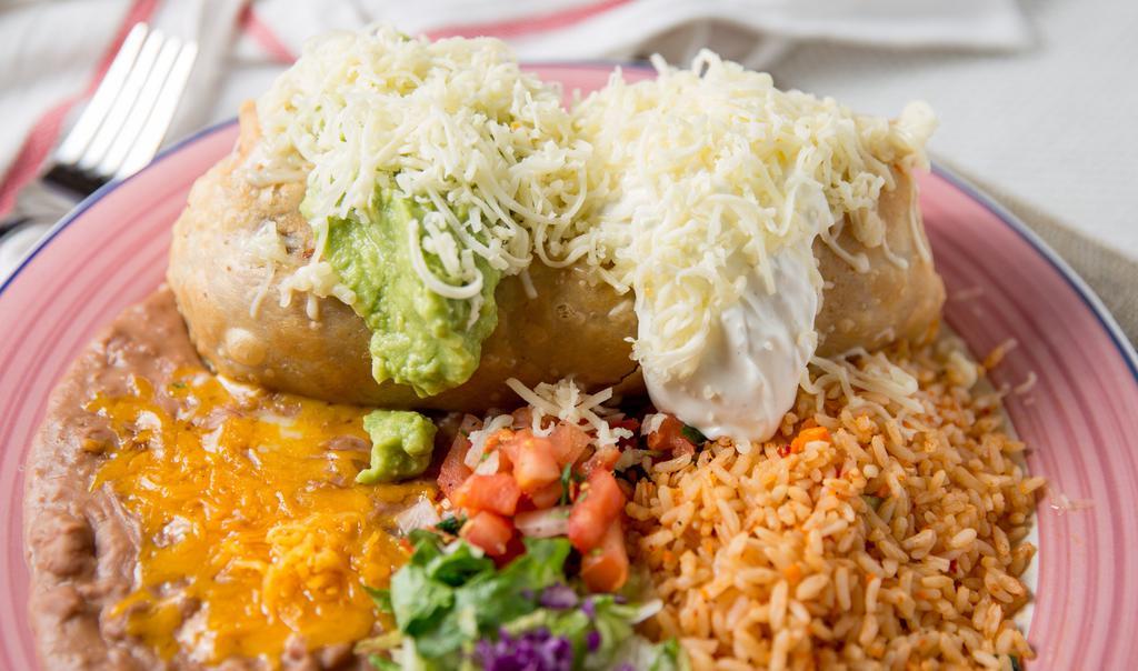 Chimichanga · Beef, pork, chicken or beans deep fried burro served with guacamole, sour cream, salsa fresca, lettuce, cheese, rice and beans.