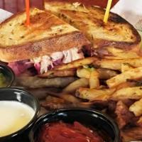 Reuben Sandwich W/ 1 Side · Corned beef, sauerkraut, thousand island dressing, Swiss cheese. Served with soup, salad, or...