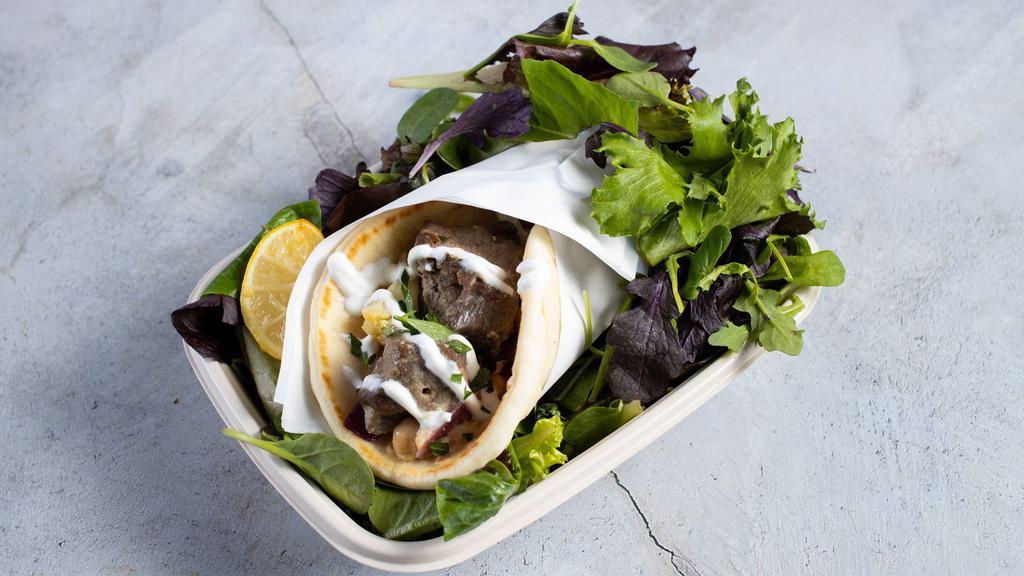The Genie'S Gyro · Doner style lamb served in hot pita bread. Served with Tomatoes, lettuce onions, green peppers and homemade sauce tzatziki, garlic and hot.