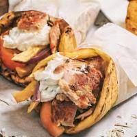 The Shawarma Sensation Gyro · Delicately marinated shawarma served in a hot pita bread. Topped off with tomatoes, onions, ...