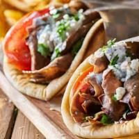 The Dessert Shawarma Gyro  · Chicken Shawarma is served in hot pita bread. Served with Tomatoes, lettuce onions, green pe...