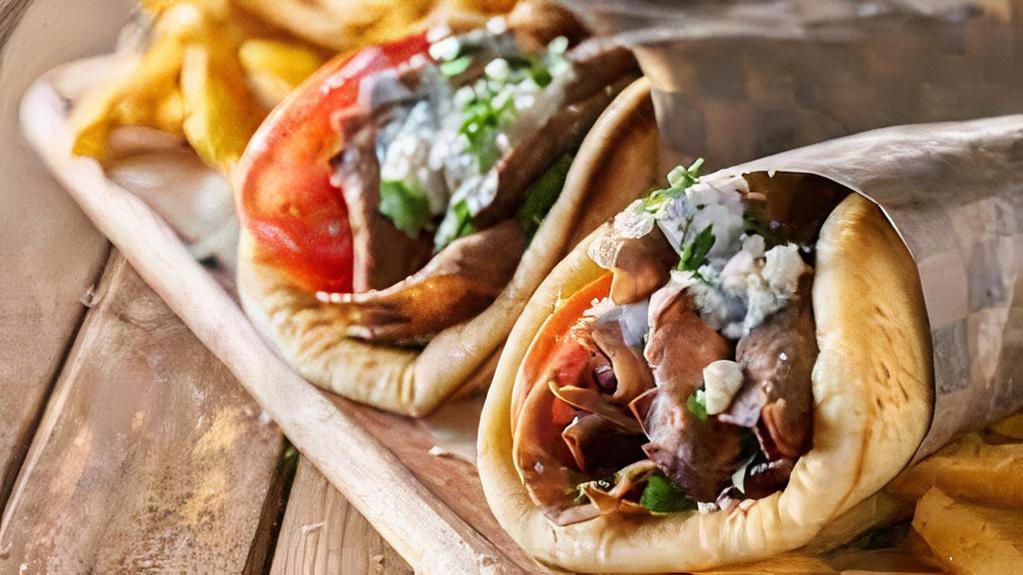 The Dessert Shawarma Gyro  · Chicken Shawarma is served in hot pita bread. Served with Tomatoes, lettuce onions, green peppers and homemade sauce tzatziki, garlic and hot.