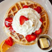 Belgian Waffles · Served with strawberries and  fresh whipped cream.