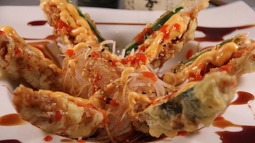 Heart Attack · 3  jalapeño peppers stuffed with cream cheese, crab stick, and spicy tuna, deep fried and served on a bed of daikon. Topped with teriyaki sauce, spicy mayo, sesame sauce, and sriracha.