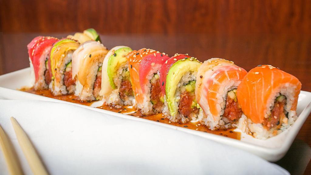 Spicy Rainbow Roll · Spicy tuna and cucumber,avocado inside with tuna, salmon, albacore, white fish, yellow tail, and spicy sauce on top.