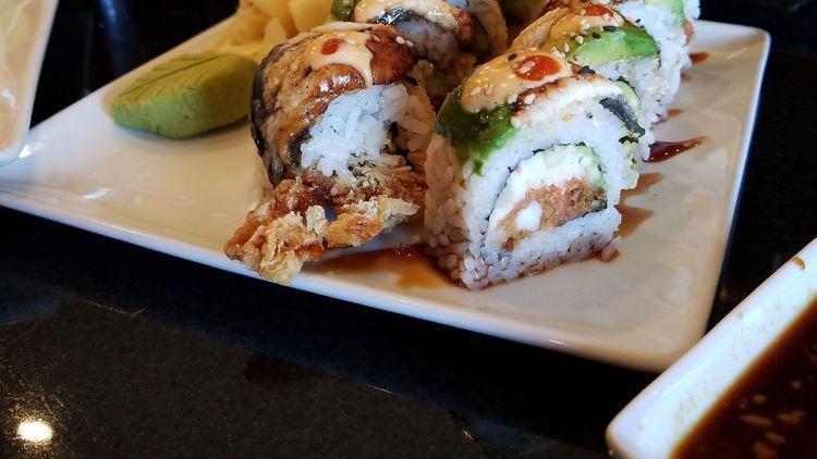Godzilla Roll · Cucumber, avocado, soft shell crab, and spicy tuna inside with eel, eel sauce, and spicy mayo on top.