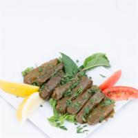Vegetarian Grape Leaves · Mix of rice chopped greens, herbs, and spices all rolled in a grape leave and pita bread.