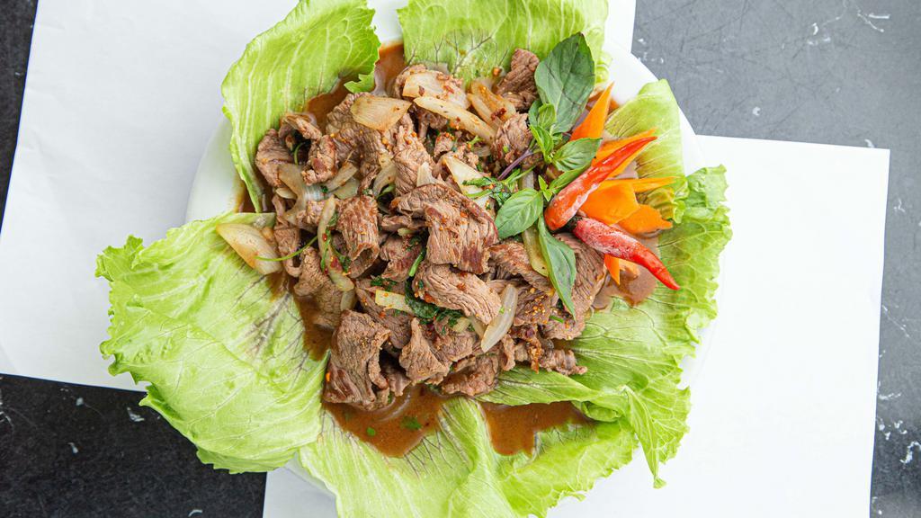 Beef Waterfall · Thinly sliced steak, onions, toasted rice powder, & cilantro served with sticky rice