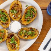 Potato Skins · Loaded with green onions, cheese, and bacon. Served with sour cream.