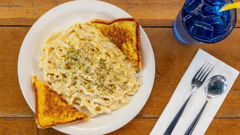 Fettuccine Alfredo · Fettuccine noodles with a rich and creamy Alfredo sauce. Parmesan topped served with grilled garlic toast. Add Chicken, Shrimp, Steak & Mushrooms for an additional charge.