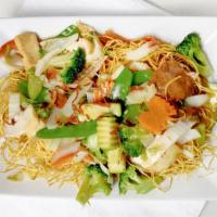 Pan Fried Noodles (Phở Áp Chảo) · Fresh stir-fried veggies, tofu, soy protein, mushroom & onion atop a crispy crush of pan-fri...