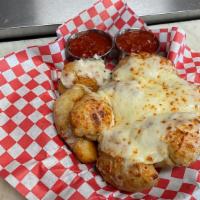 Garlic Knots With Melted Mozzarella · Served with a side of homemade marinara sauce.