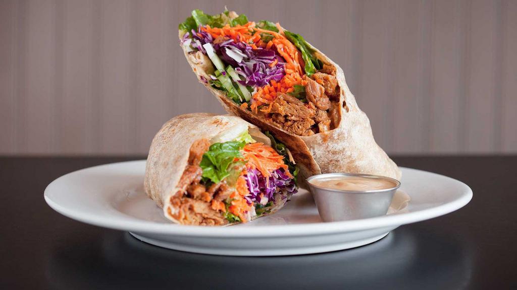 Thai  Wrap · spinach, cucumber, red bell peppers, carrots, mint, cilantro, cabbage, coconut, peanut dressing & peanut-tamari soy curls wrapped in a whole wheat tortilla