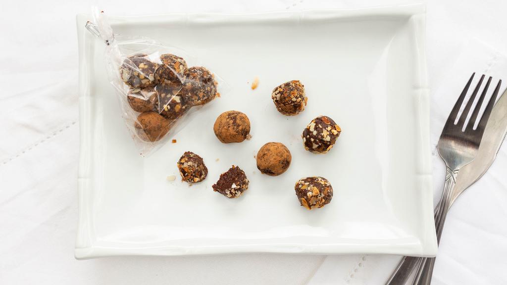 Chocolate Energy Truffles · Made with medjool dates and almond milk. Rolled in toasted almonds, cacao powder and toasted coconut. (V)