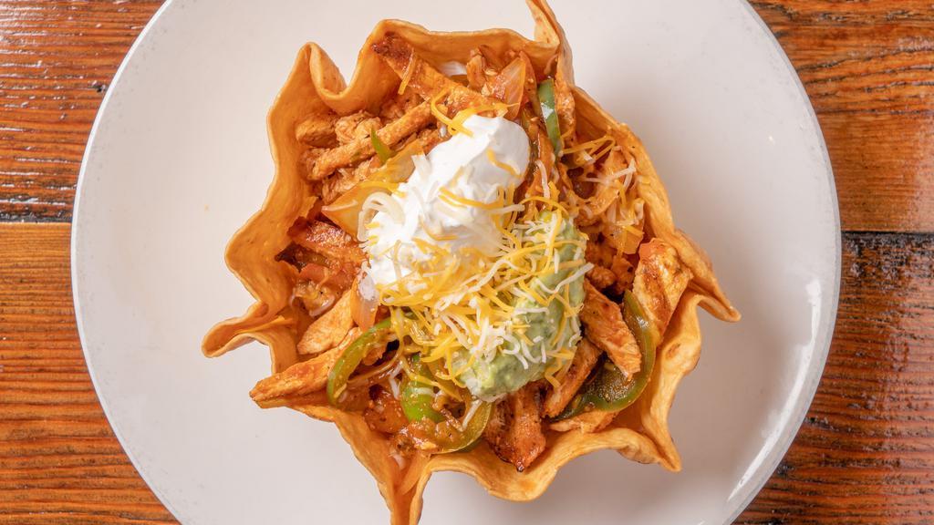 Fajita Taco Salad · Crisp tortilla basket with your choice of mesquite-grilled steak or chicken or prawn fajitas sautéed with mushrooms, bell pepper, and onions, filled with beans, rice, lettuce, cheese, guacamole, and sour cream.
