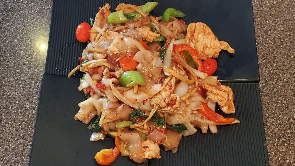 Pad Khee Mao (Drunken Noodle) · Stir fried flat rice noodle, garlic, chili, bamboo, carrot, tomatoes, onion, bell pepper and basil.