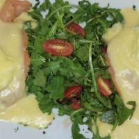 Smoked Salmon Benedict · Two poached eggs on German potato pancakes with hollandaise, served with arugula salad.