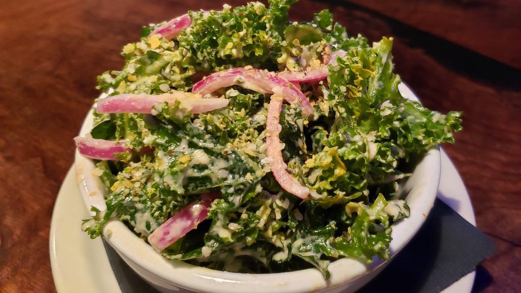 Kale Salad · marinated kale, toasted sunflower seeds, pickled onion tossed in a tahini dressing.