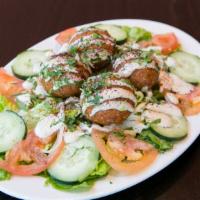 Falafel Salad* · Falafel, romaine, tomatoes, cucumbers, and onions tossed in Greek dressing, topped with Tahi...