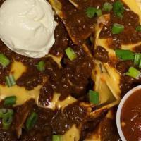 Nachos · A heaping pile of tortilla chips topped with red chili, queso, green onion, and sour cream. ...