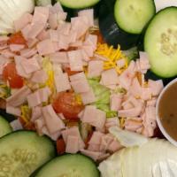 Chef Salad · Mixed greens, turkey, boiled eggs, cheddar cheese, tomato, cucumbers, and choice of dressing.