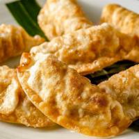 Asian Potstickers · Filled with chicken, vegetables lightly fried, served with sweet and sour sauce.