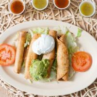 Taquitos · 4 chickn or beef taquitos served on top of lettuce with sour cream and guacamole.