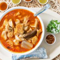 Menudo · Tripe soup. Served with a side of Chili flakes, Onion & cilantro mix and a side of tortillas.