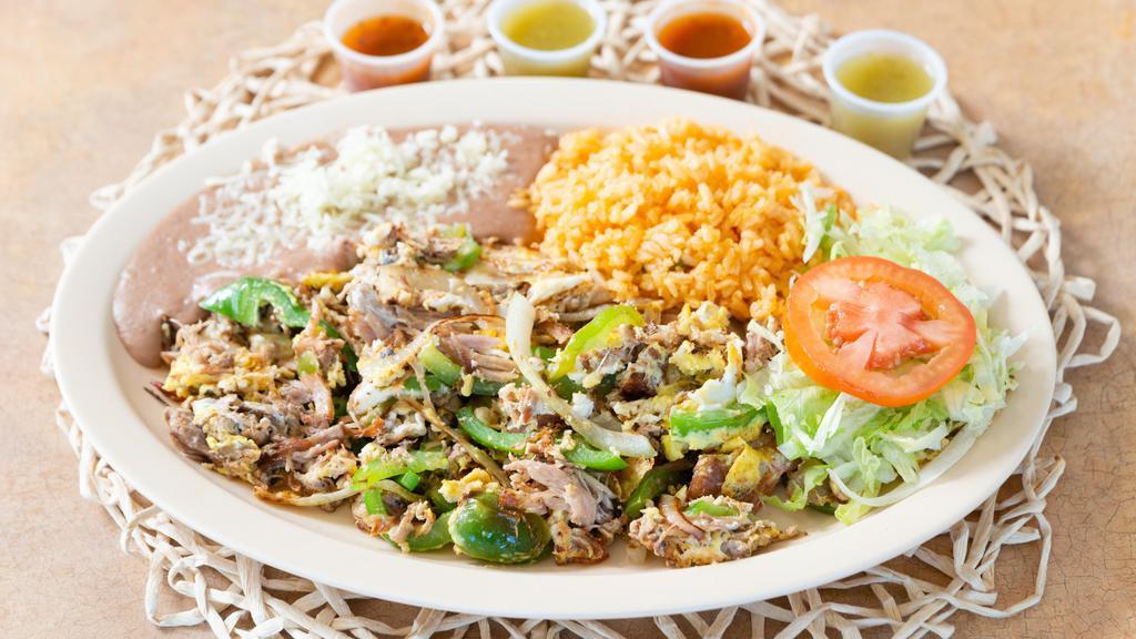 Machaca · Pork meat cooked with bell pepper, tomatoes, onions and eggs. Served with a side or rice, beans and tortillas.