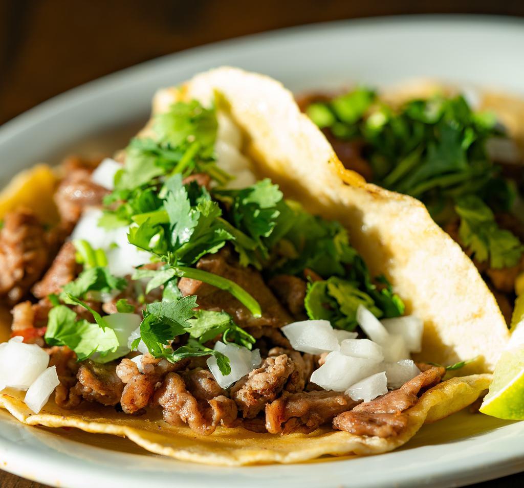 Taco · Street-style taco with cilantro and onion. Lime and salsa on the side, build it how you want it!