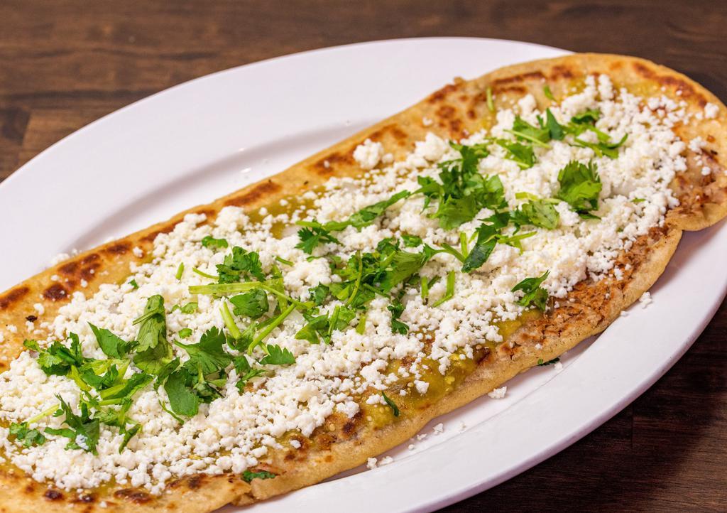 Huarache Sencillo/Basic · 13'' inch long tlaxcalli filled with beans, finished with onion, cilantro, queso fresco and salsa of your choice (Important: This item does NOT contain meat, if you want to add a topping, choose a SPECIAL Huarache).