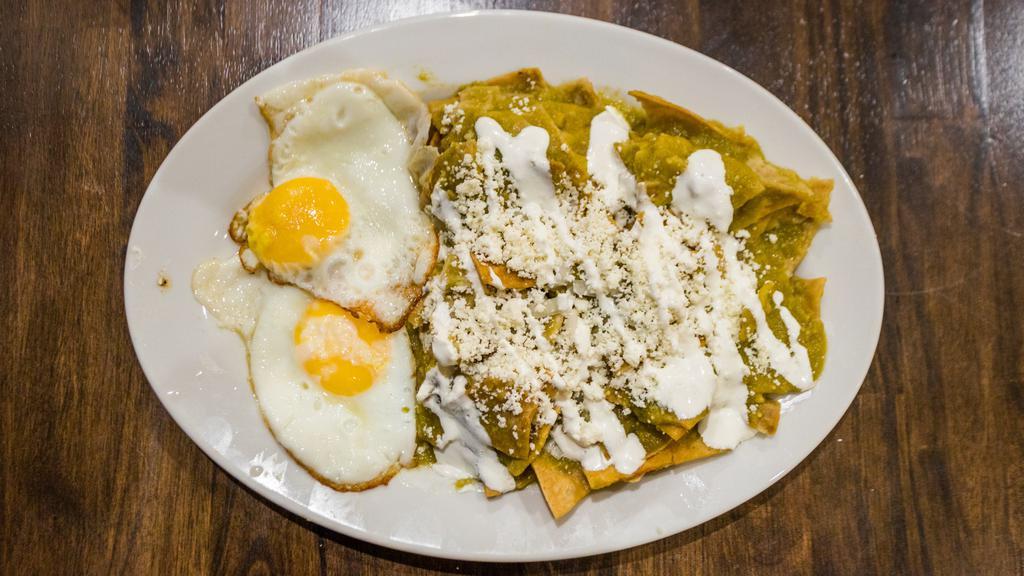 Chīlāquilitl · Handmade tlaxcalli strips, simmered in salsa, lightly fried, cooked with epazote and served with your choice of sunny-side eggs or steak.