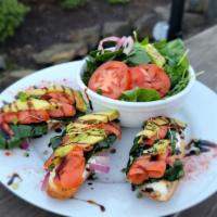 Smoked Salmon Bruschetta · Smoked Lox Salmon, cream cheese mousse, spinach salad base, red onions, avocado, finished wi...