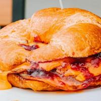 Monte Cristo Sandwich · Grilled ham, cheddar cheese, and raspberry jam all on a croissant. Comes with a fruit cup.