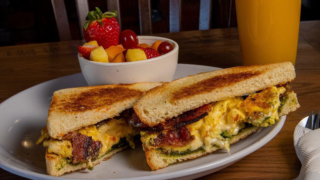 Presto Pesto Panini · Scrambled eggs, pepper jack cheese, bacon and our very own pesto spread, all sandwiched between two thick slices of sourdough. Comes with a fruit cup.
