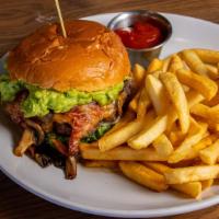 Deluxe Burger · Avocado spread, bacon, grilled mushrooms and onions, cheddar cheese, lettuce, tomato and sig...