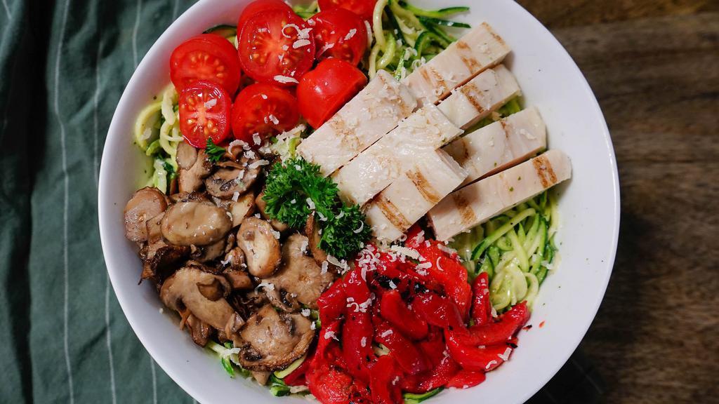 Pesto Zoodle Salad · Spiralized zucchini, basil pesto, grilled chicken breast, grape tomatoes, roasted red peppers, roasted mushrooms, Parmesan, parsley garnish. 25g fat, 12g net carbs, 39g protein, 489 cal.