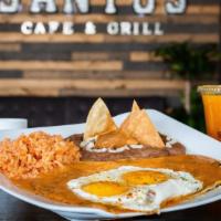 Huevos Rancheros · Two fried tortillas topped with two eggs smothered in green chile (with a side of rice and b...
