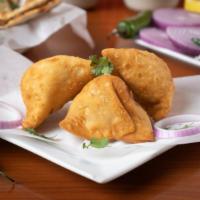Samosa · A delectable duo of handmade crisp cones filled with potatoes, peas, cumin, spiced, and seas...