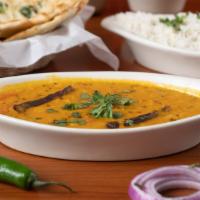 Tadka Dal (Tomato) · Loosened yellow lentil cooked with spices, tomato, green chilli, cumin, and onions.