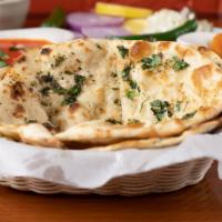 Garlic Naan · Bread baked in tandoor grill and topped with garlic.