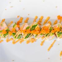 Ocean Beauty Roll · Eight pc - salmon, avocado, topped with crab salad, seaweed salad, masago (fish roe)