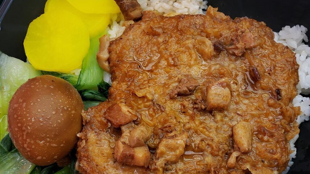 Braised Pork Chop / 滷排骨飯 · Fried pork chop dipped into marinade sauce includes white rice egg vegetable