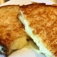 Classic Grilled Cheese · Aged Cheddar and Gruyere blended with miso butter, and toasted to golden brown.